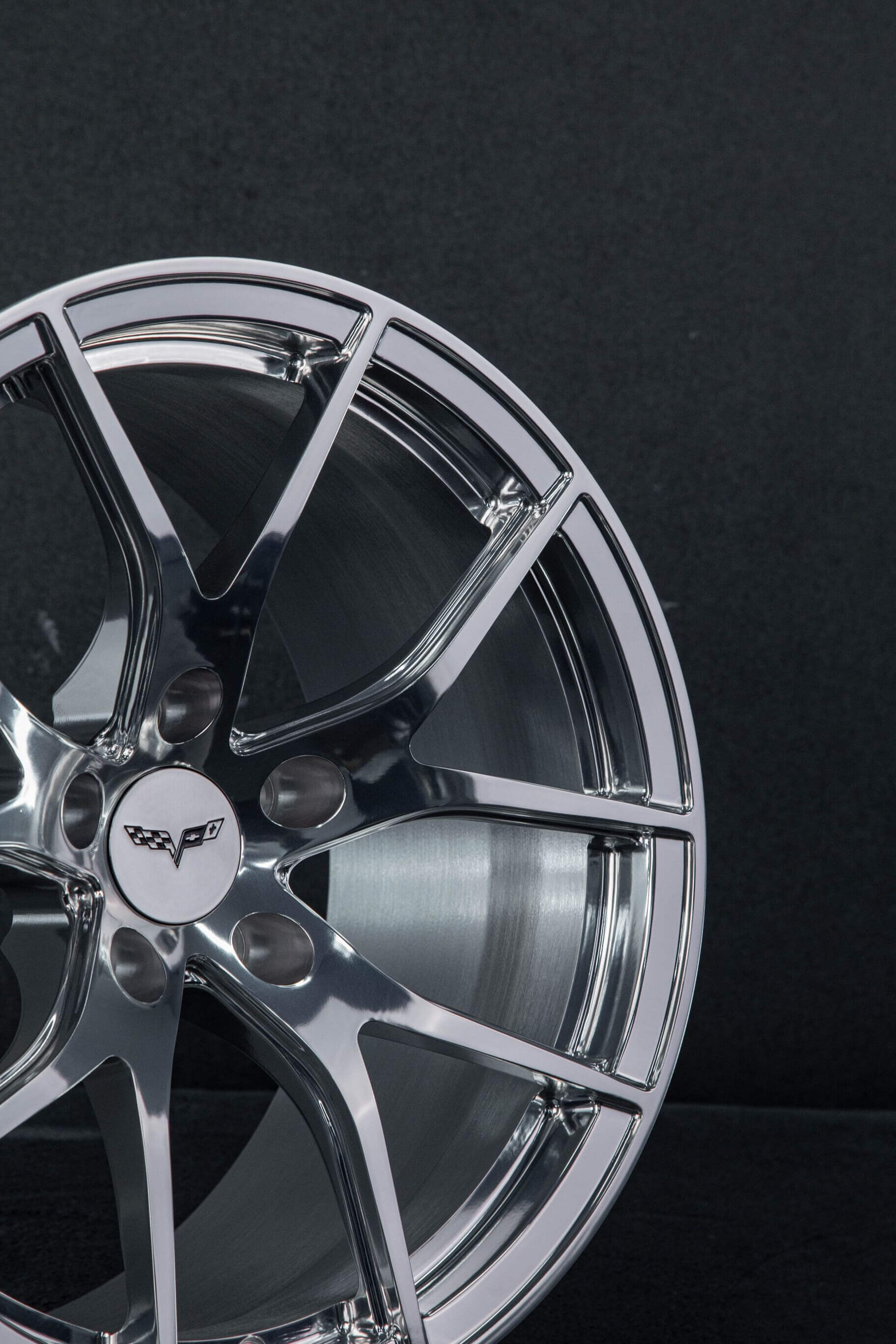 Glossy polished finish reflecting light on forged RV-MC24 wheel surface.