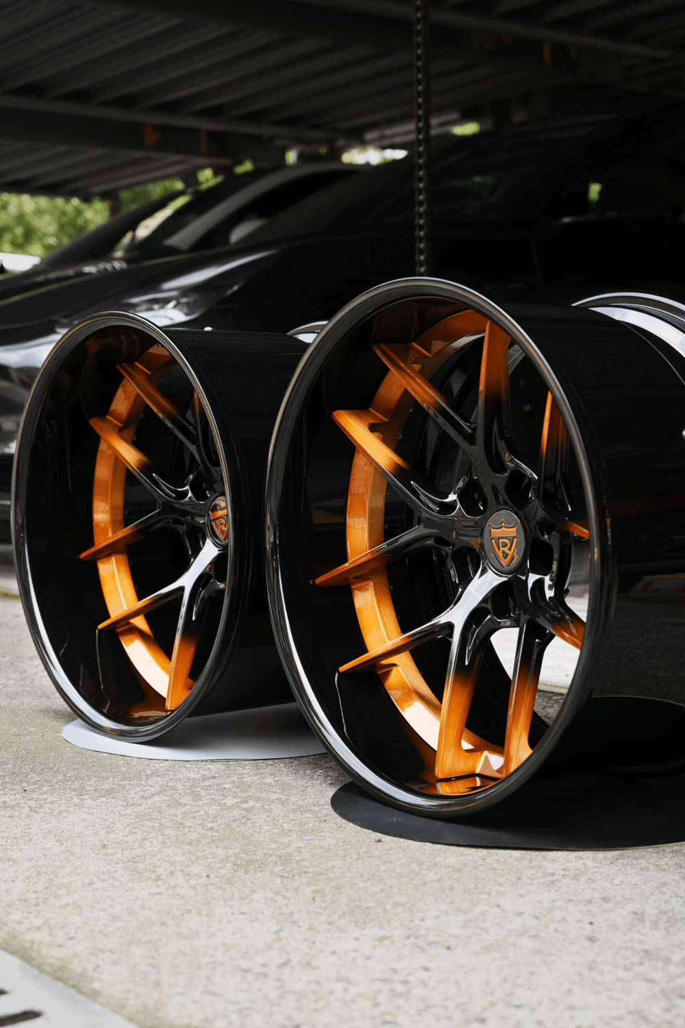 2013 Dodge Challenger copper black custom forged wheels by RVRN Wheels displayed on a concrete surface
