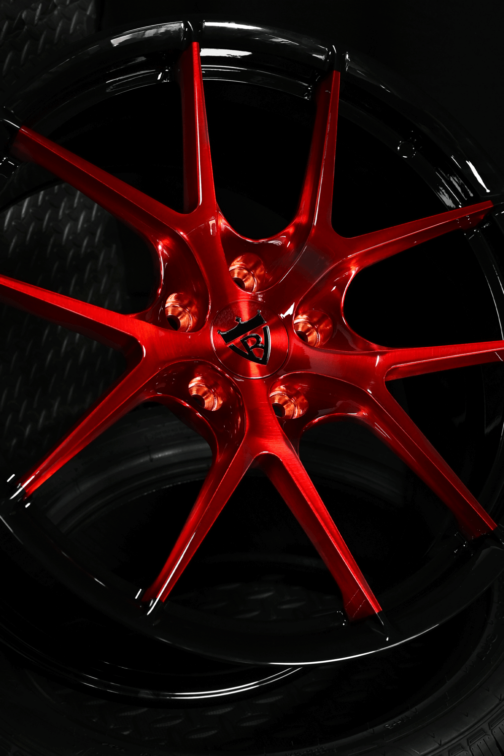 Custom red wheels on 2014 C7 Corvette with aggressive concave styling.