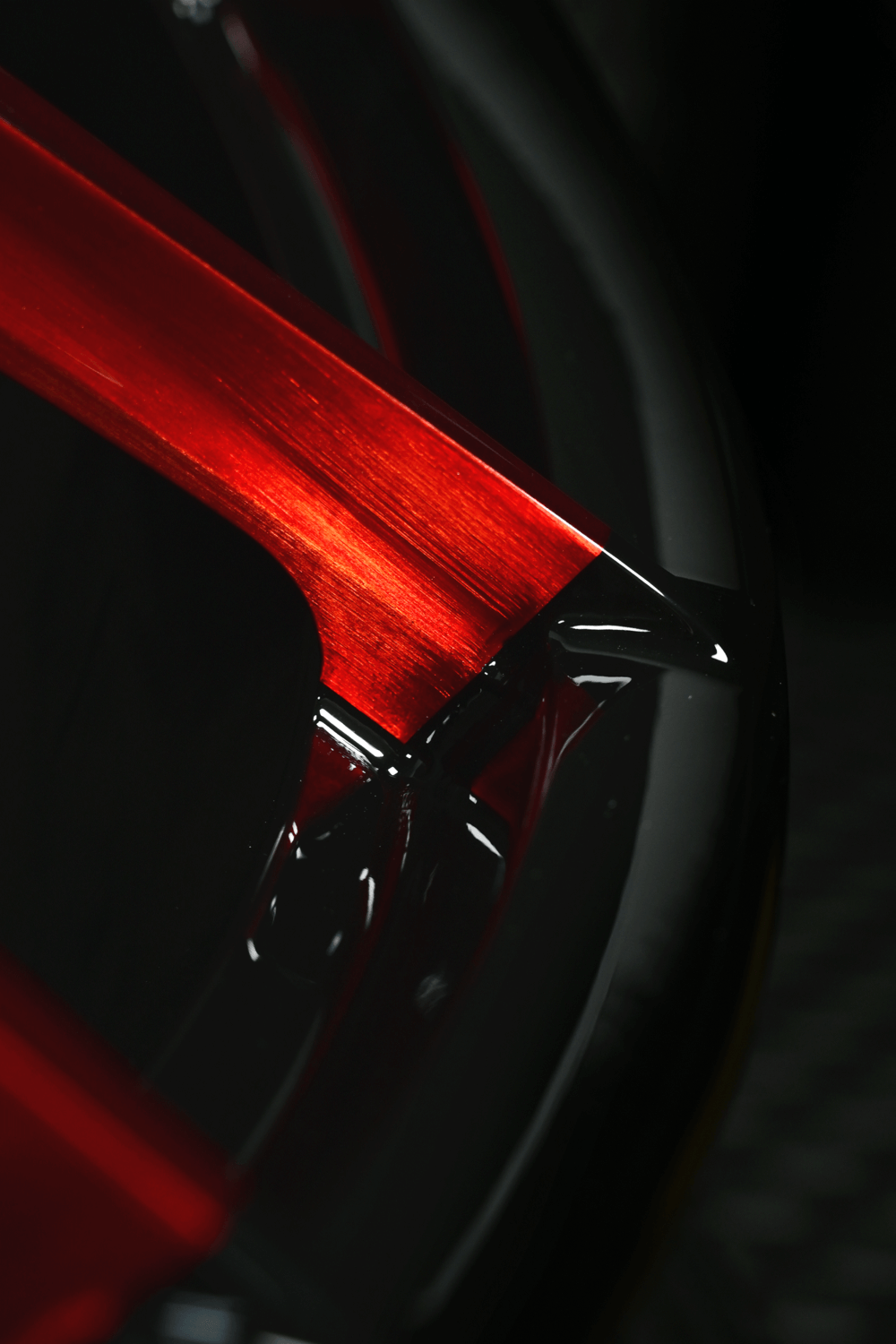 Close-up of RV-MR05 forged one-piece red and black wheels for Corvette.
