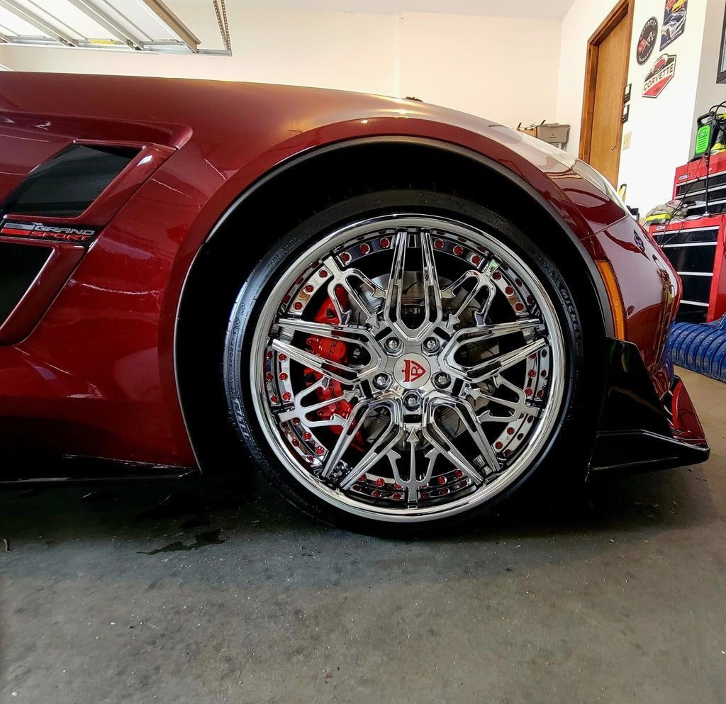 Rear wheel view of C7 Grand Sport showing custom 21x12 chrome setup