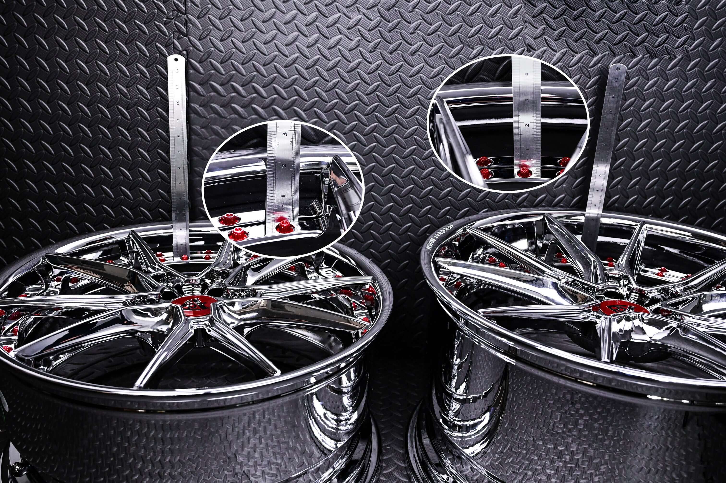 Chrome wheels for C8 Corvette displayed on a textured surface, showcasing design and detail for 2021 Corvette models.