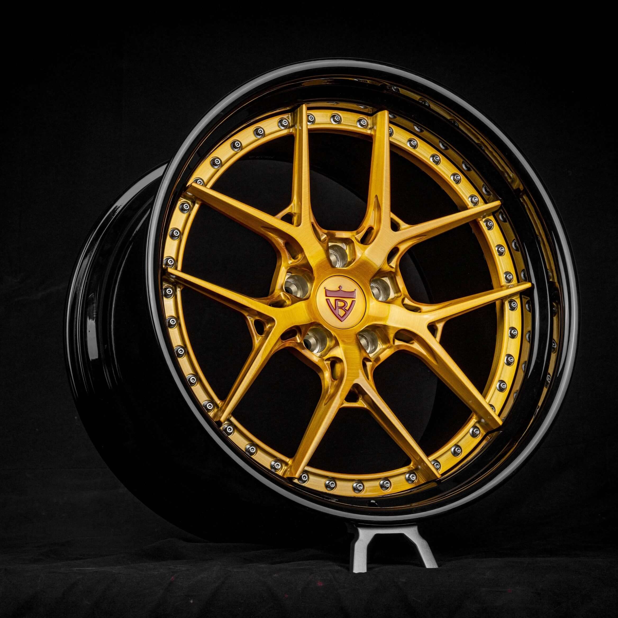 Custom dark gold and black deep dish wheel for Tesla Model S Plaid with 21-inch staggered rim design against a black background.