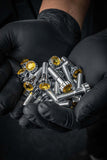 Crystal Shiny Screws for custom-forged rims with yellow rhinestones held in hands wearing black gloves