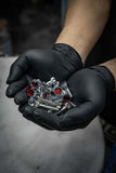 Hands holding Crystal Shiny Screws with red rhinestones for custom 6 lug rims and Dodge Dakota R/T wheels.