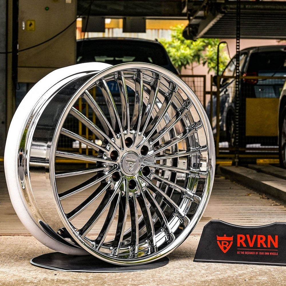 GMC Yukon custom forged black chrome wheel showcased in automotive display area, highlighting its shiny finish and intricate design.