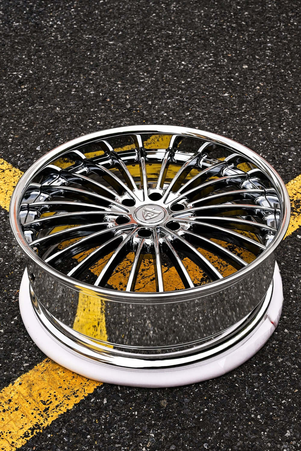 GMC Yukon black chrome custom forged truck wheel showcased on asphalt, emphasizing sleek design and high polish finish.