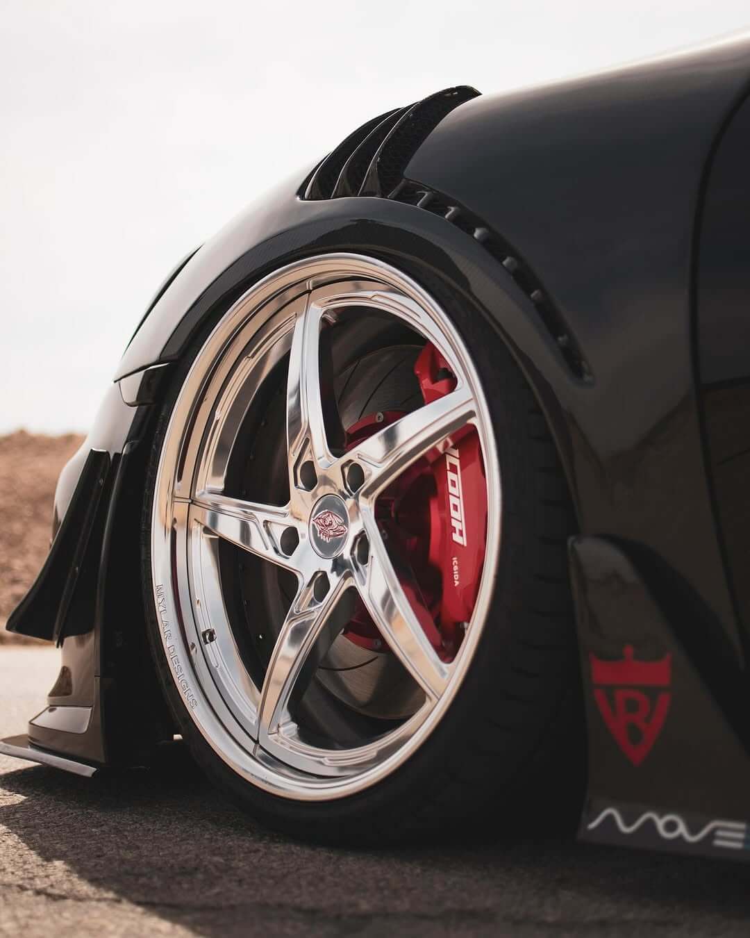 2014 Porsche Cayman side view with 21inch staggered deep dish wheels.