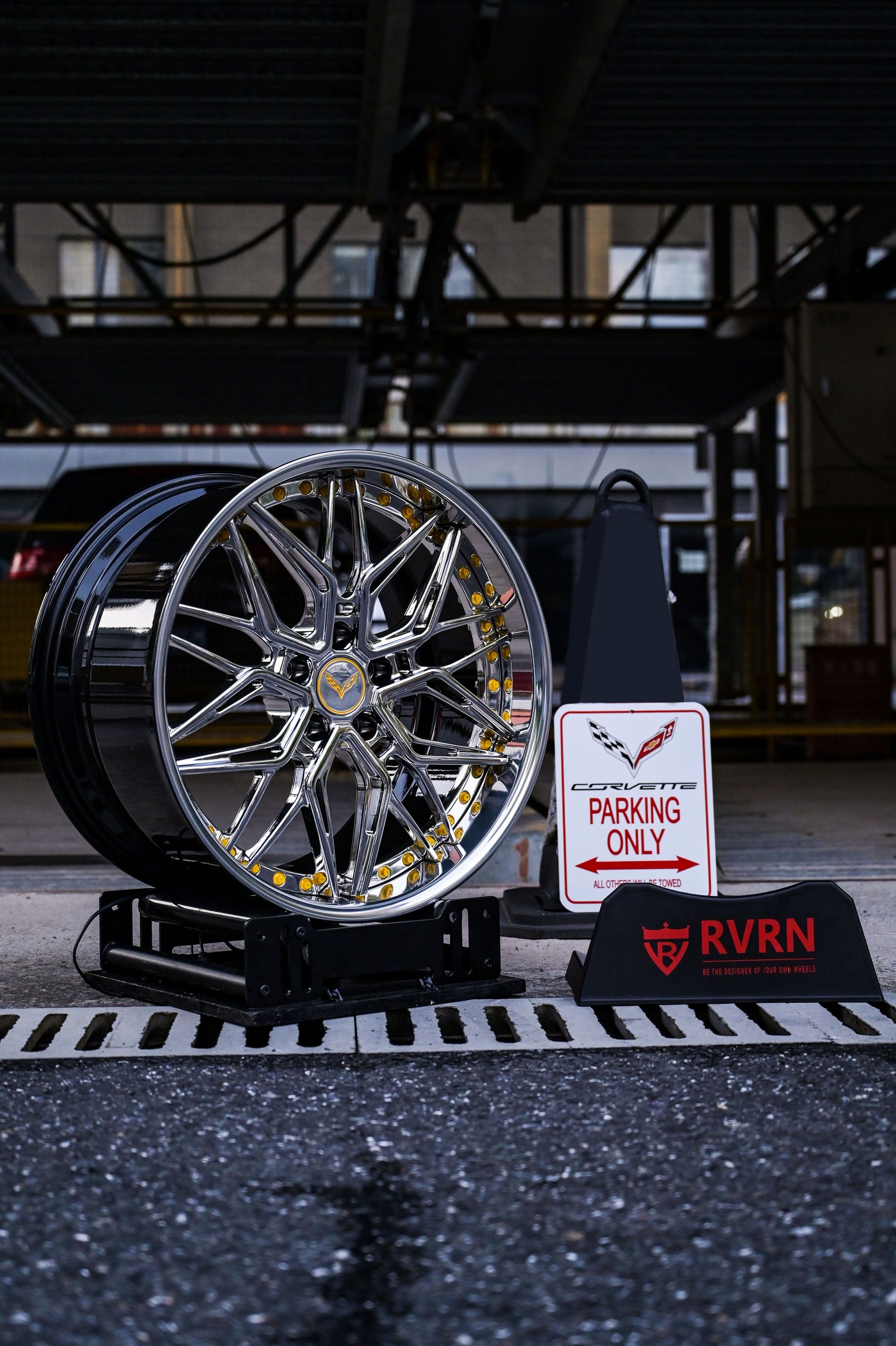 Chrome Corvette C7 deep dish wheels displayed next to a Corvette-only parking sign.
