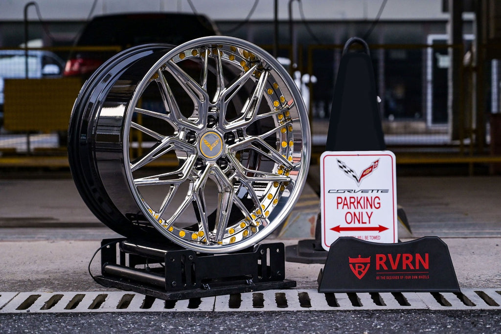 Corvette C7 deep dish chrome rims displayed next to a parking sign.