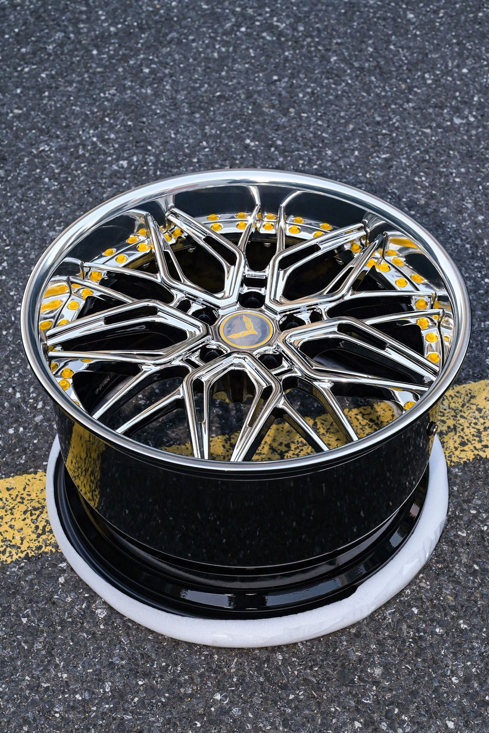 Chrome Corvette C7 deep dish wheel on asphalt, featuring intricate design, perfect for enhancing style of your Corvette with new rims.