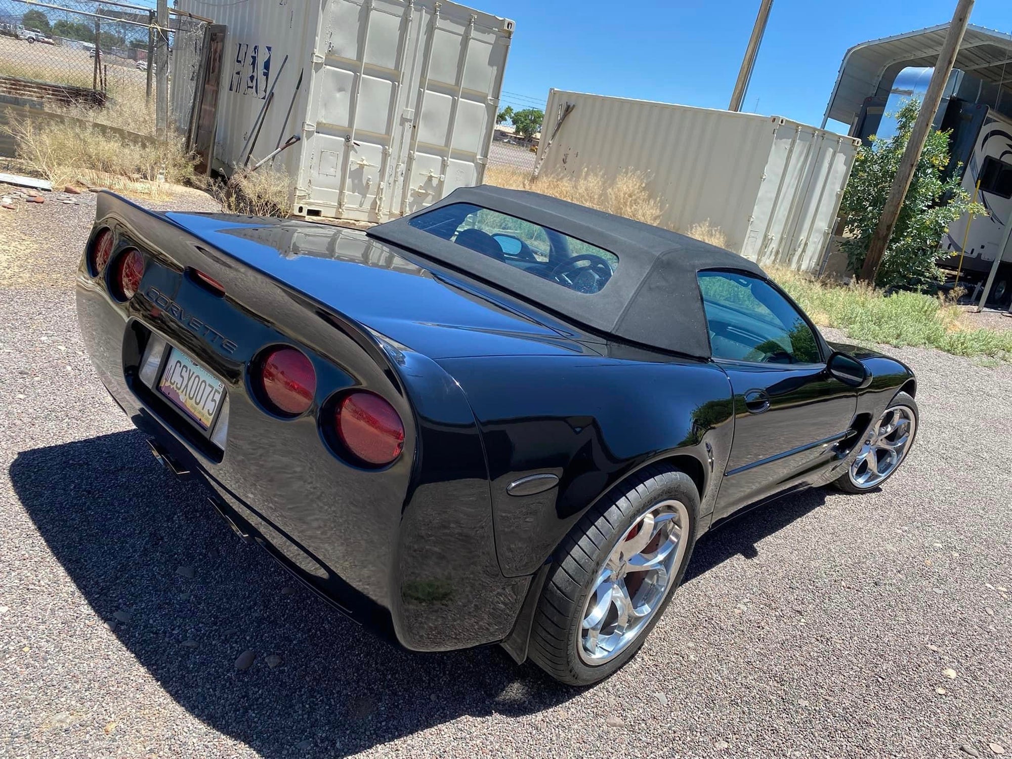 2000 Corvette C5 convertible with polished aluminum wheels parked outdoors, showcasing custom forged wheels.