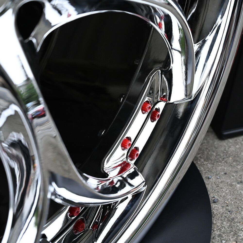 Close-up of custom forged wheels with chrome finish and red accents, ideal for Alfa Romeo Giulia aftermarket rims.