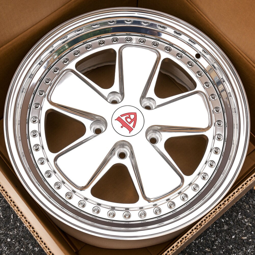 Custom forged 5 spoke deep dish wheel for Porsche 911, showcasing polished finish and intricate design.