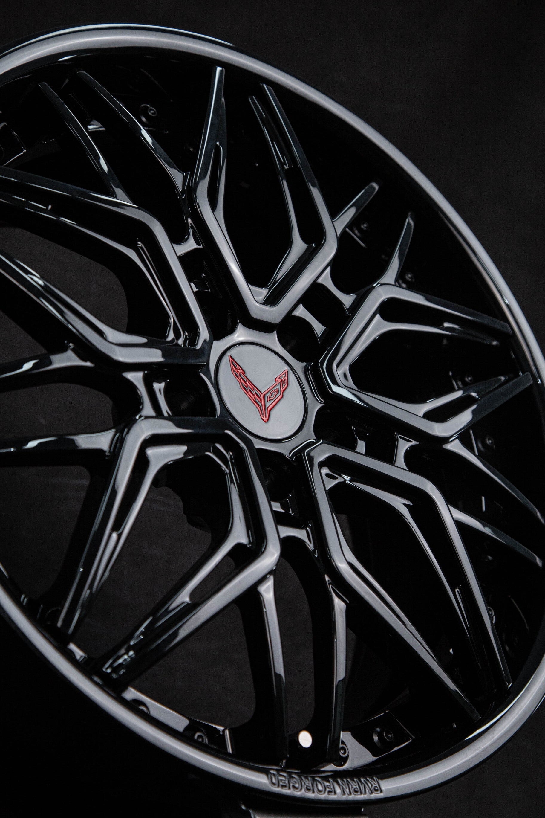 Close-up of black C8 Corvette custom wheels featuring deep dish design, showcasing luxury and performance.