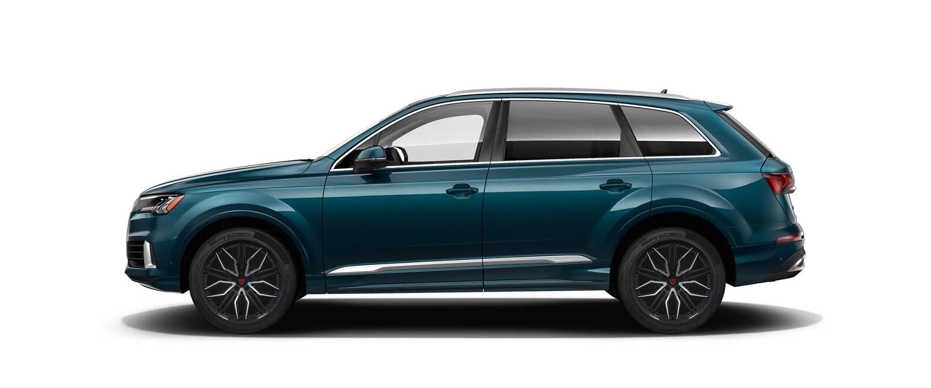 teal Audi SUV side view with custom black and orange rims