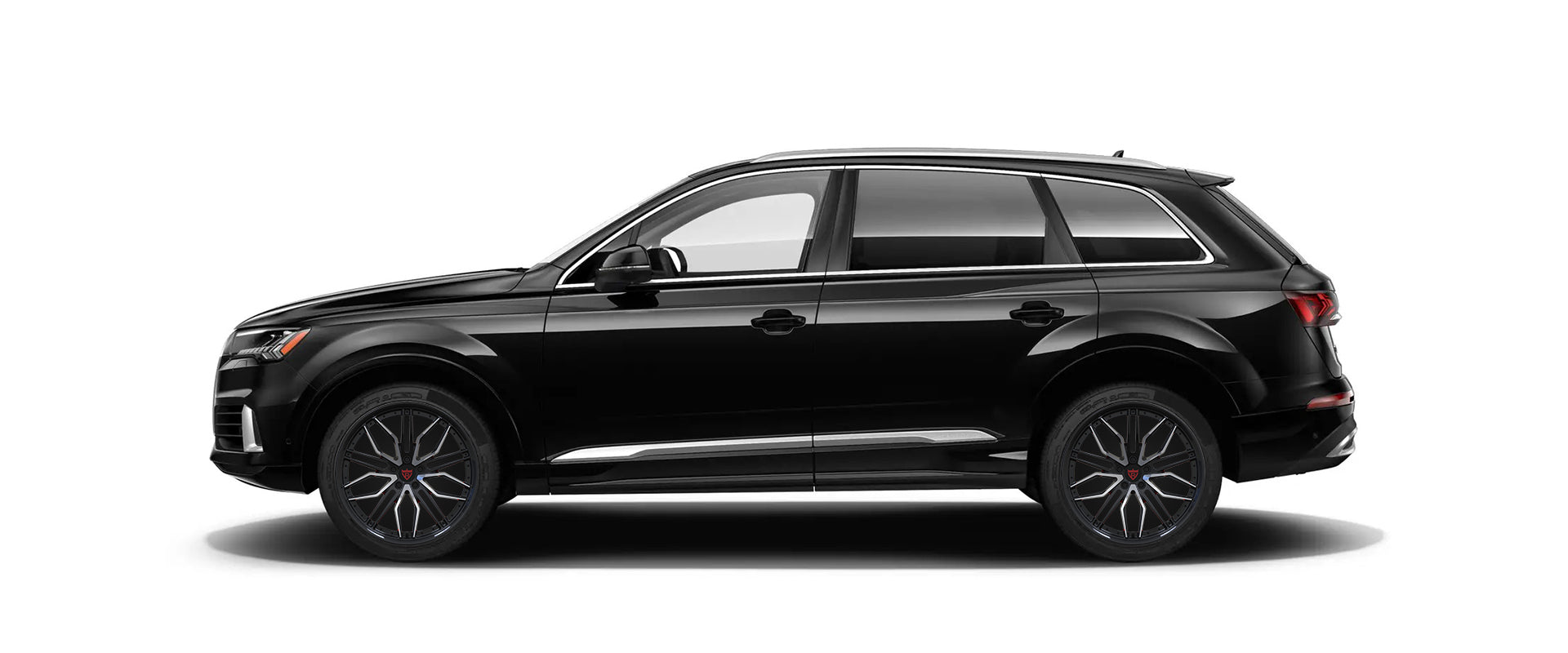 Black SUV with custom black and orange forged wheels, side view.