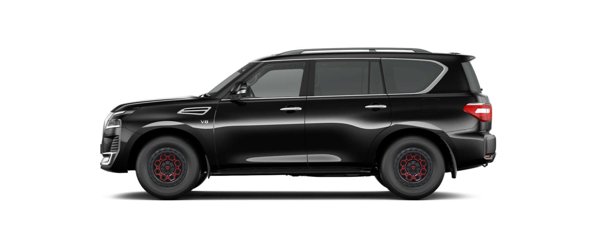 Side view of a black SUV with distinctive red rims, showcasing a sleek and modern design.