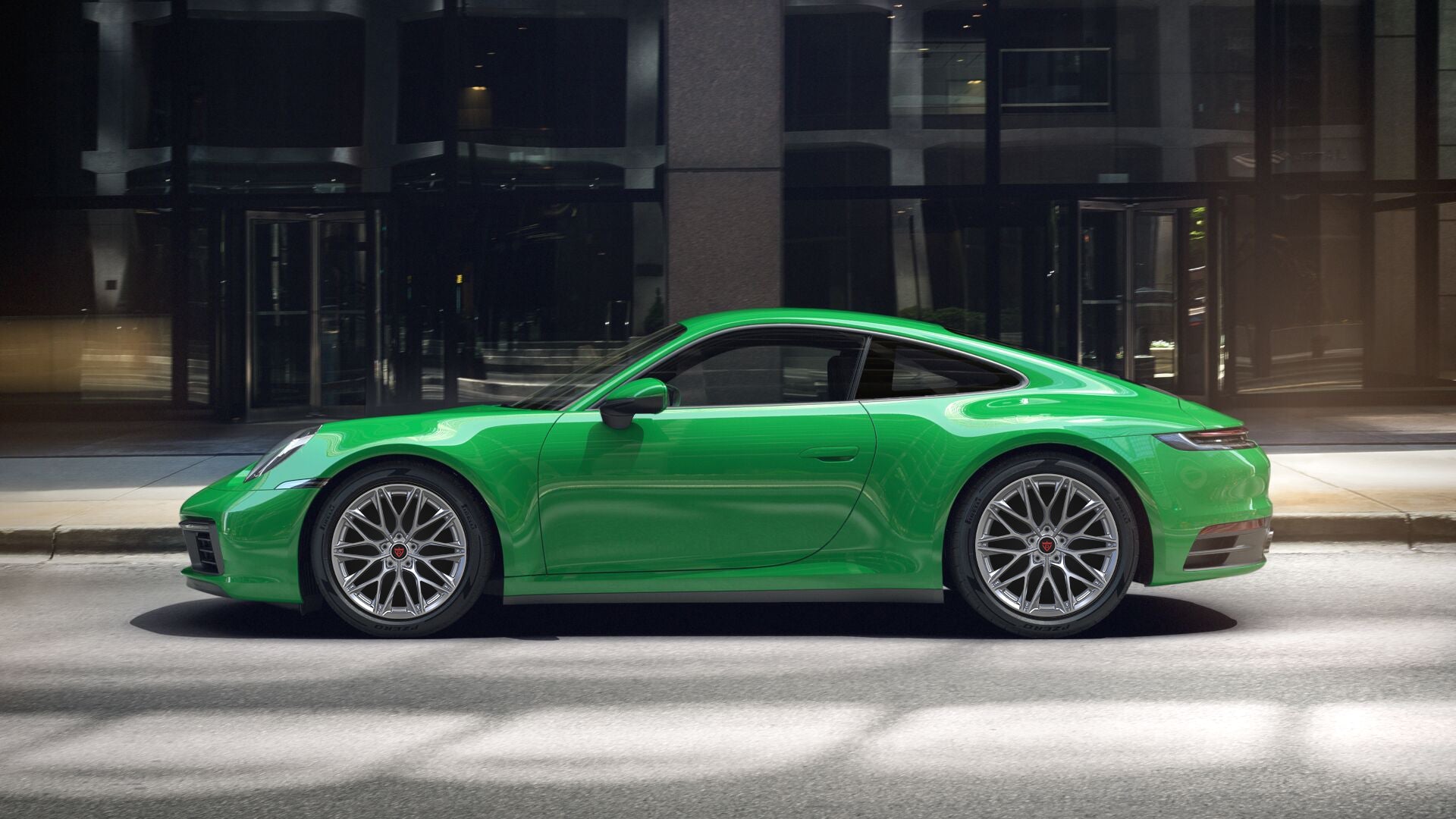 Green Porsche 911 showcasing custom forged monoblock wheels, highlighting luxury and performance.