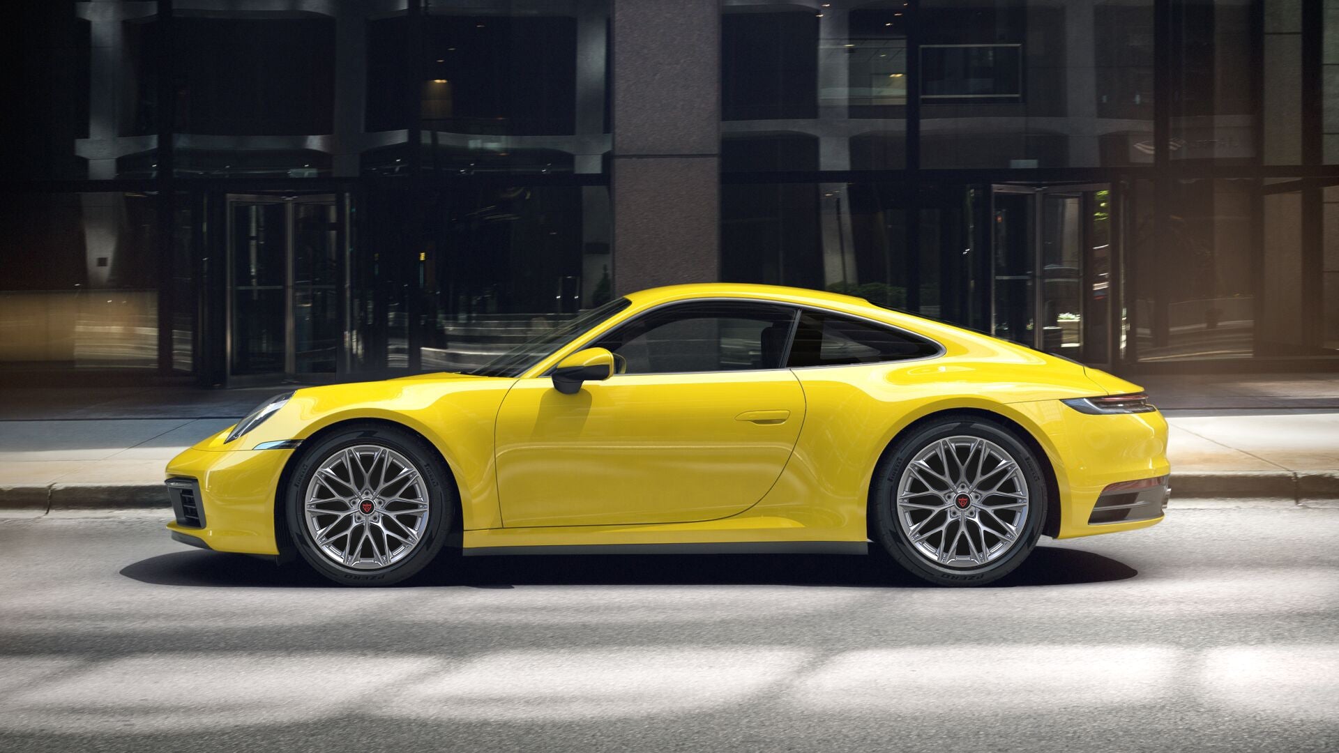 Yellow Porsche 911 showcasing custom forged monoblock RV-MP184 wheels on city street.