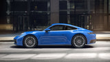 Stylish blue Porsche 911 showcasing custom forged monoblock wheels on a city street, highlighting premium aftermarket design.