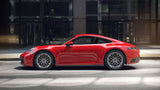 Red Porsche 911 sports car featuring custom forged monoblock wheels, parked on a city street.