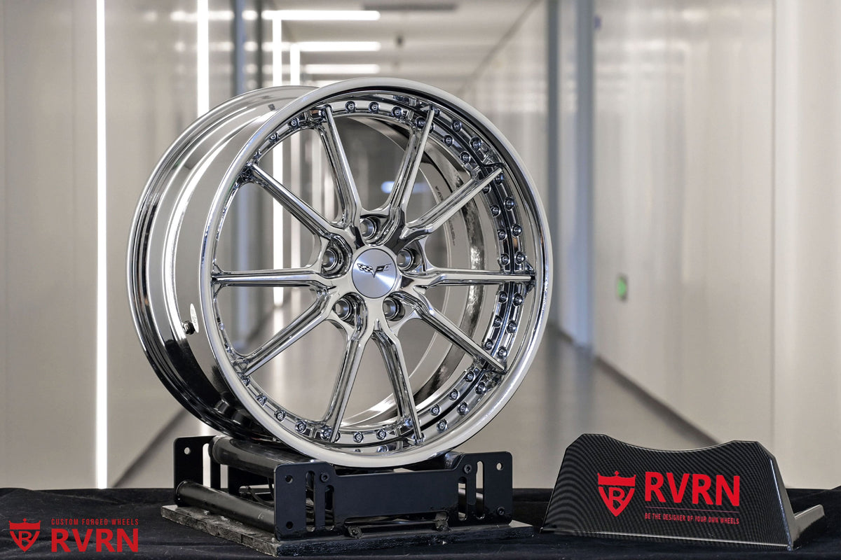 2005 C6 Base Chrome Wheels: RV-DC05 displayed with RVRN logo on a custom stand in a sleek environment.