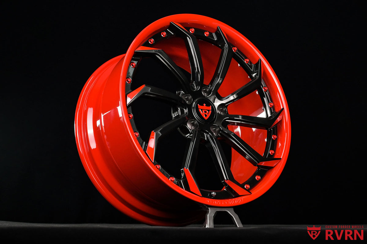 Close-up of custom Corvette C7 wheels featuring the RVRN RV-DC01 directional design, red barrel and contrasting red and black spokes