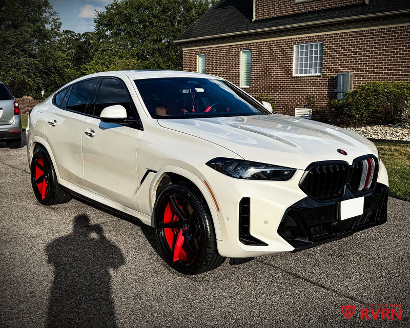 Front three-quarter view of a 2026 BMW X6 M on RVRN RV-MC35 5-spoke concave custom forged wheels in red and black two-tone, 22x10 front and 22x11.5 rear.