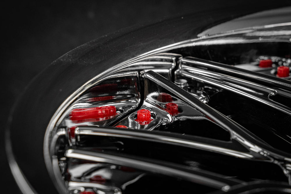 Close-up of the black chrome RVRN RV-T081 forged wheel spokes with the red brake caliper behind, 1973 Corvette C3
