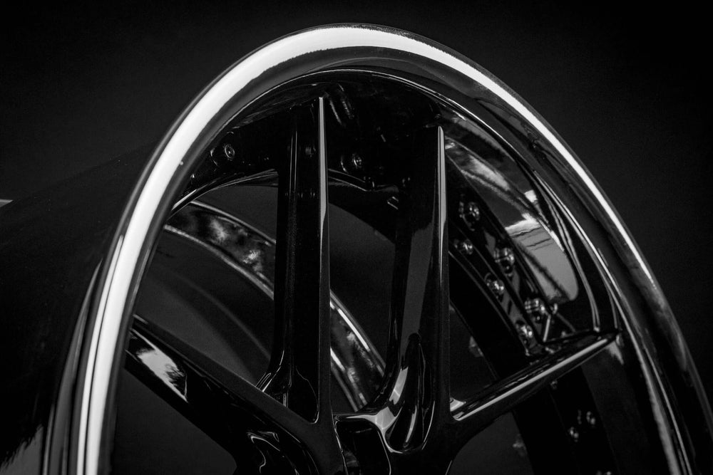 Close-up of custom black Mustang GT500 wheel for 1994 model.