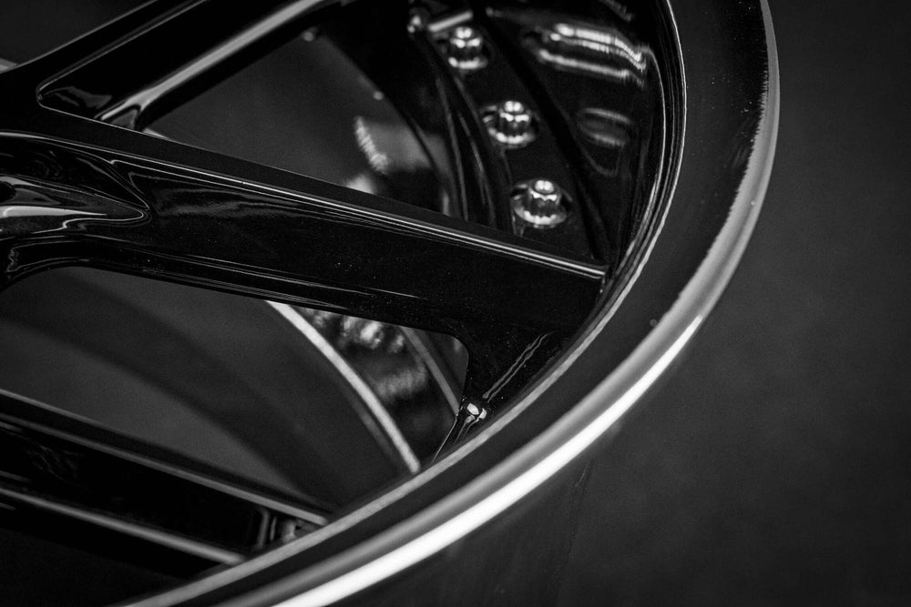 Custom black 1994 Mustang GT500 wheels close-up showing sleek design and intricate detailing