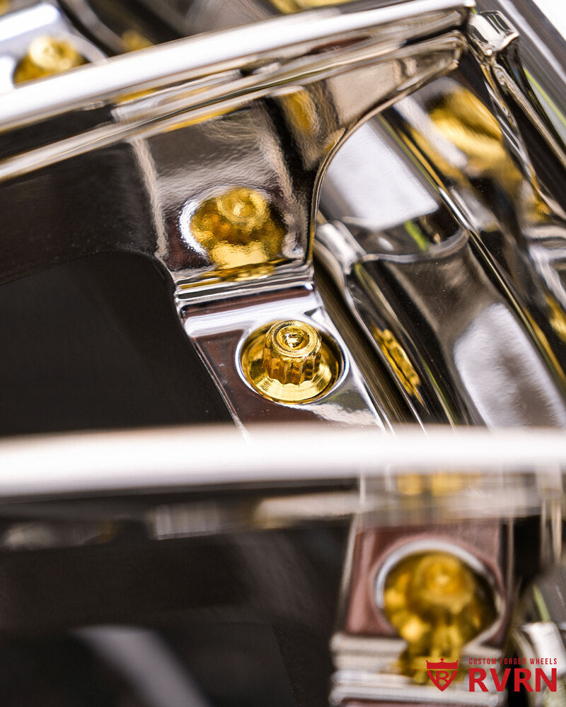 Close-up of RV-DN01 chrome spokes and gold-toned rim bolts for Mercedes-Benz CL600