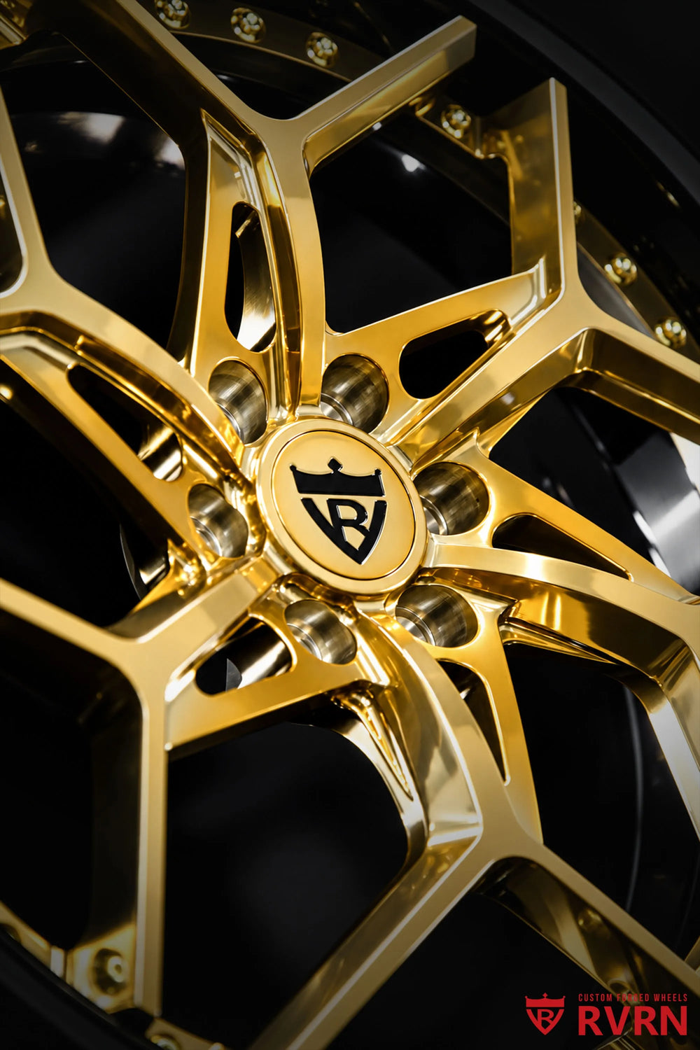 2008 Cadillac STS Rear Wheel Drive RV-DV03 2-piece forged Y-Spoke wheels with Gloss Black Barrel, Polished Frozen Gold Spoke, and gold screws, shown in a close angled detail of the spoke junction and center hub with reflective gold spokes, black barrel sections, exposed lug openings, and RVRN center logo visible against a dark background.