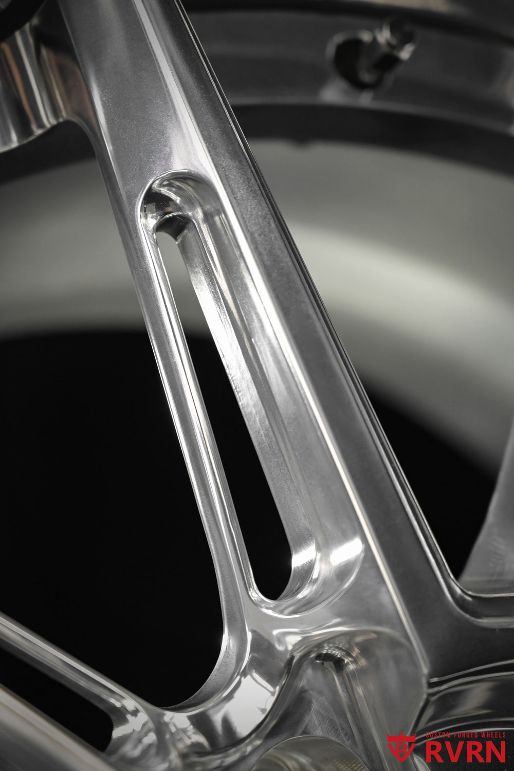 Close-up detail of an RVRN RV-DC26 multi-spoke forged wheel for a 2009 Corvette C6 Base, showing the polished spoke face, sculpted spoke opening, machined transition, and reflective All Polished finish.