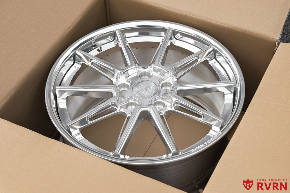 Loose RVRN RV-DC26 multi-spoke forged wheel for a 2009 Corvette C6 Base shown inside a cardboard shipping box, highlighting the polished spokes, polished rim edge, deep barrel, and finished wheel face.