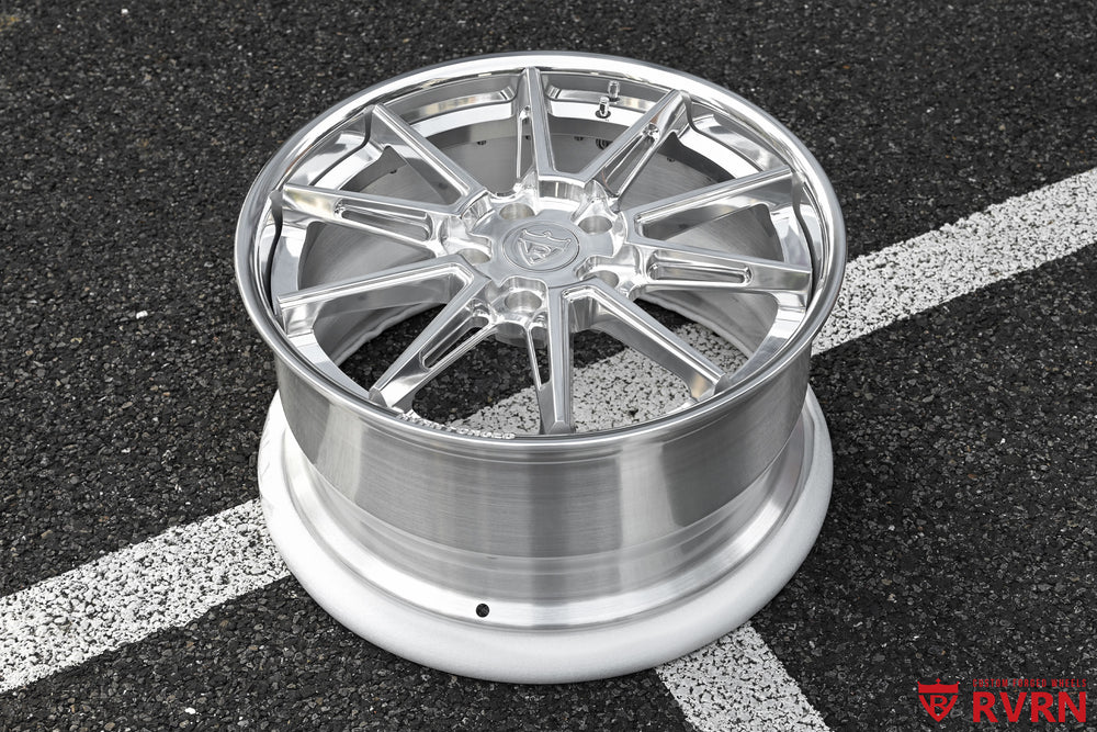 RVRN RV-DC26 multi-spoke forged wheel for a 2009 Corvette C6 Base photographed on asphalt, showing the polished spokes, wide deep barrel, outer rim profile, and All Polished finish from an angled top view.