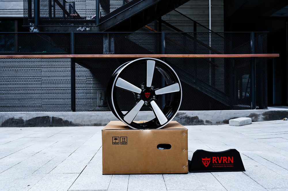 RVRN RV-MP223 forged wheel for a 2011 Chevy Camaro LT resting on a carton outdoors with the RVRN sign, brushed spokes and gloss black barrel in 18x7.5 fitment.