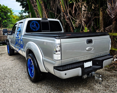 2012 Ford F250 Super Duty on RVRN RV-DR08D custom forged wheels in Blue Chrome, rear view with custom center caps and 20x11 rear fitment.