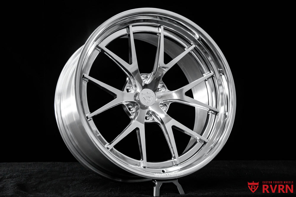 Side profile of a 2013 Cadillac Escalade equipped with custom 22x10 RVRN forged wheels for an aggressive street fitment.