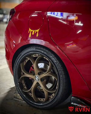 Close-up of the matte bronze and gloss black RVRN RV-DS016 forged wheel on the rear axle of a 2013 Alfa Romeo Giulietta, parked in a garage.