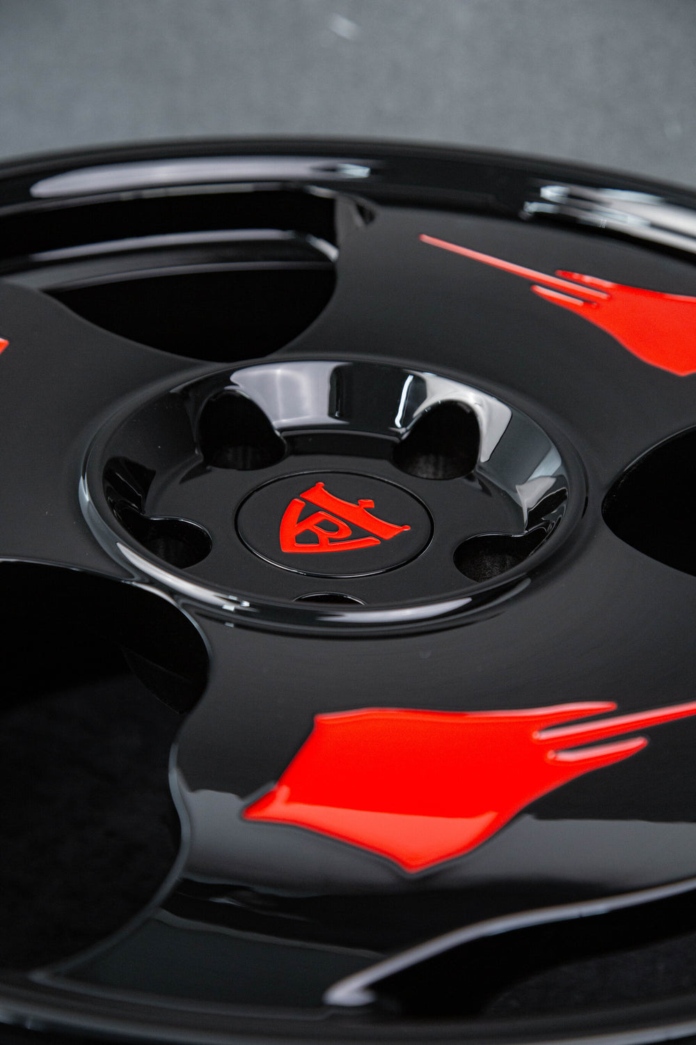 Zoomed-in look at red and black color contrast of Corvette rims