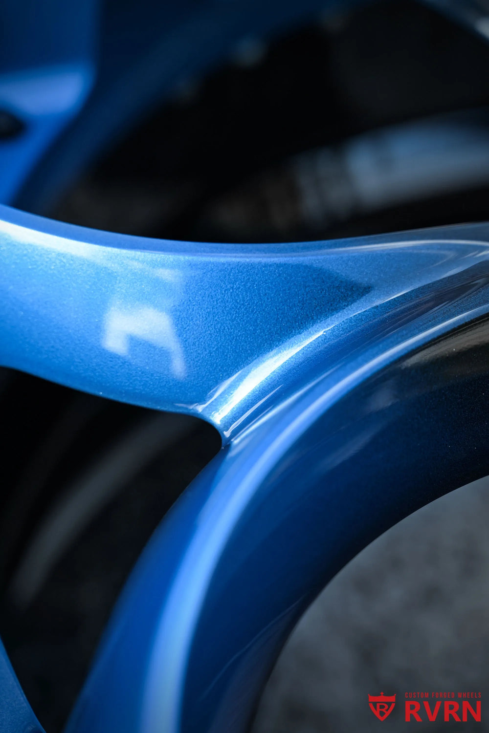Close-up of a 2015 Corvette C7 Z51 RV-DS016 forged 2-piece wheel, highlighting the blue gradient spoke surface, Gloss Black Barrel edge, polished reflections, and exposed black fasteners