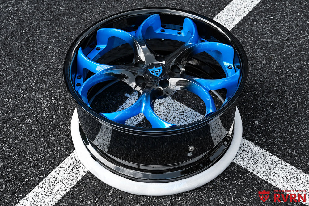 Outdoor three-quarter view of a 2015 Corvette C7 Z51 RV-DS016 forged 2-piece wheel, showing the blue gradient spokes against the Gloss Black Barrel and the deep dish side profile