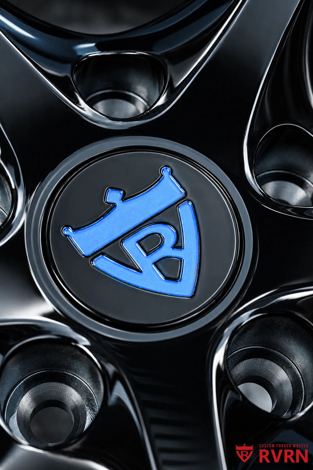 Close-up of the 2015 Corvette C7 Z51 RV-DS016 wheel center cap, lug holes, and glossy black spoke surfaces with the custom blue accent visible around the hub