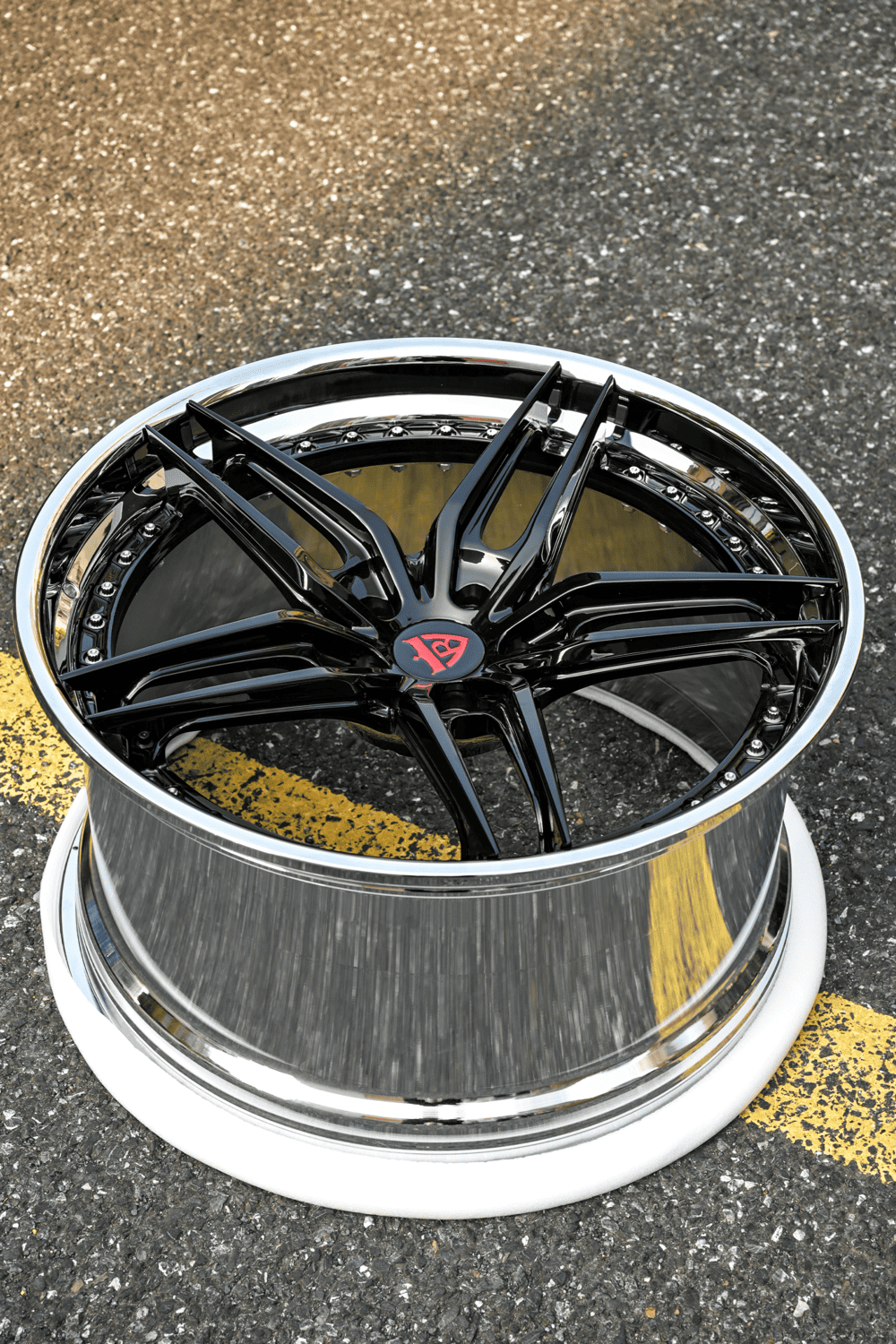 Gloss black split-spoke RVRN RV-DP03 forged wheel with a polished barrel on the shop floor, custom concave wheels for the 2016 Corvette C7 Stingray