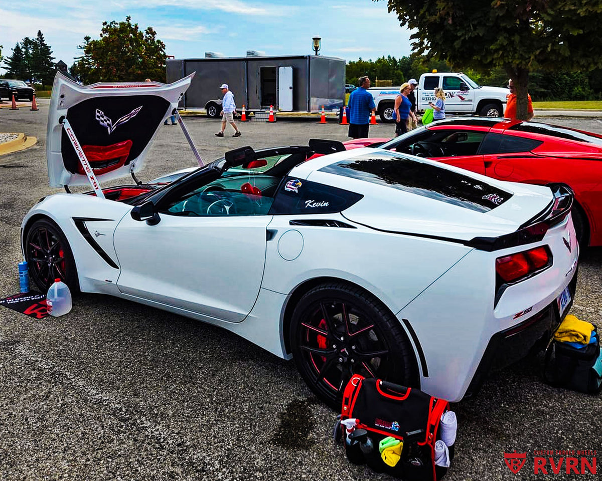 White 2016 Corvette C7 Stingray Z51 on RVRN RV-MC61 monoblock custom forged wheels in Gloss Black with Polished Red accents, flush fitment front view at a Corvette car show.