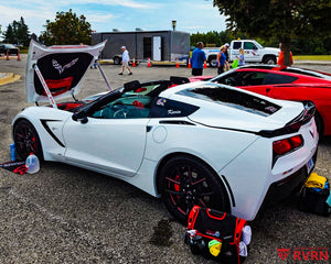 White 2016 Corvette C7 Stingray Z51 on RVRN RV-MC61 monoblock custom forged wheels in Gloss Black with Polished Red accents, flush fitment front view at a Corvette car show.