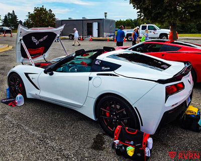 White 2016 Corvette C7 Stingray Z51 on RVRN RV-MC61 monoblock custom forged wheels in Gloss Black with Polished Red accents, flush fitment front view at a Corvette car show.