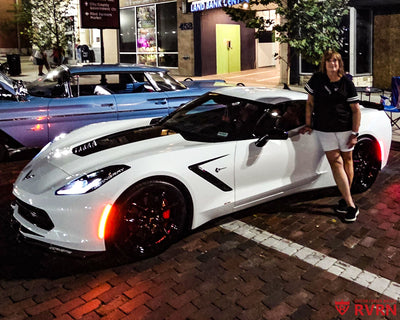 2016 Corvette C7 Stingray Z51 with RVRN RV-MC61 flush fitment forged wheels in Gloss Black and Polished Red, front three-quarter view at a downtown cruise-in.